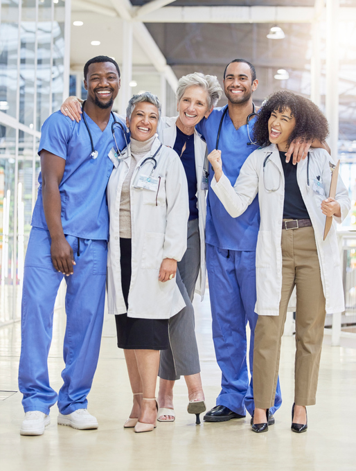 multiracial group of medical professionals in hospital wearing scrubs and lab coats