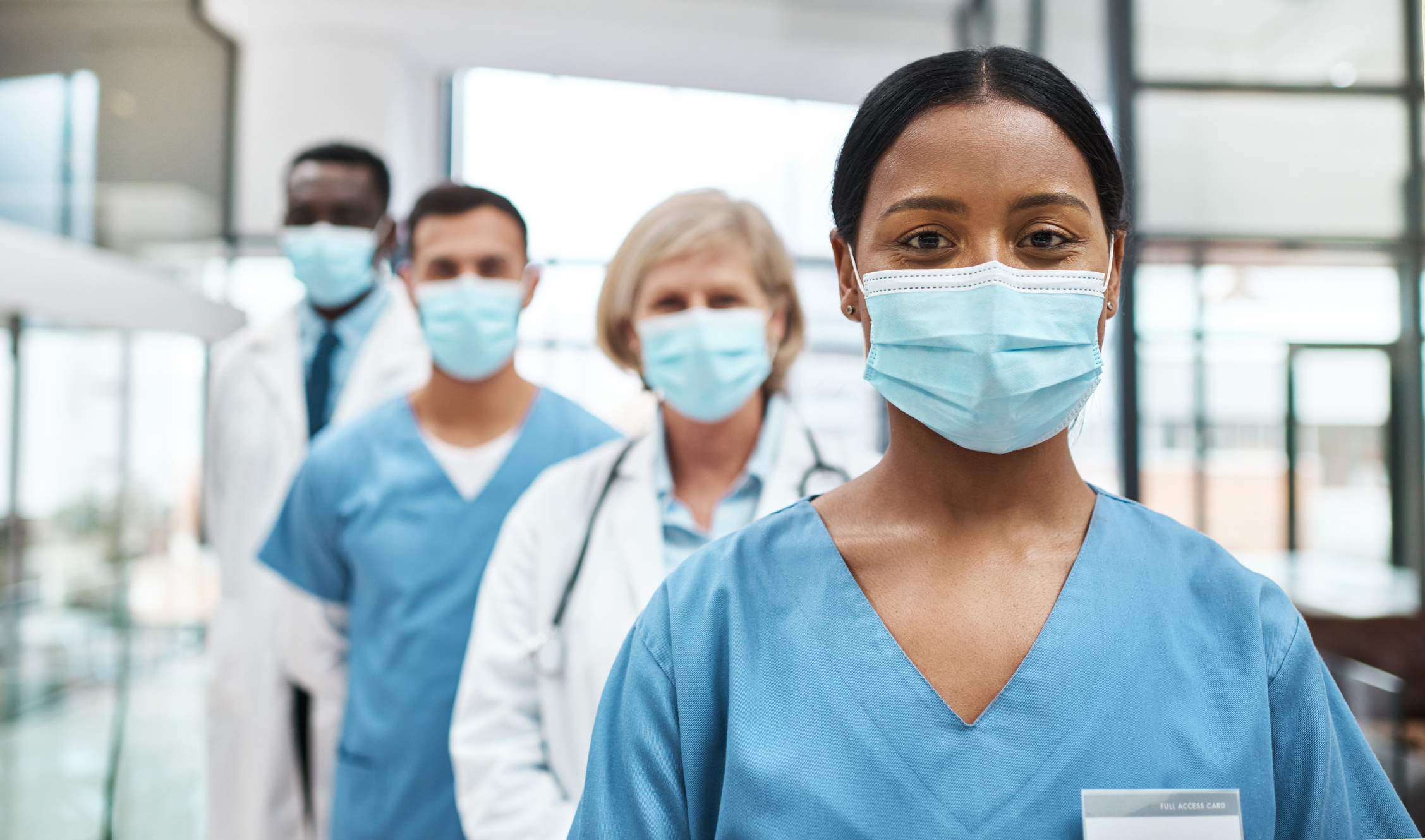 Doctors with masks on lined up in single file line