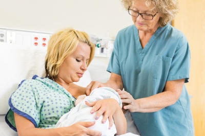 Mom breastfeeding baby in hospital