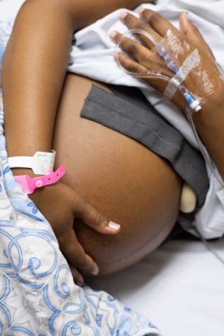 Black pregnant person hospital bed