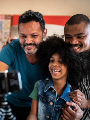 dads of color with smiling child of color 