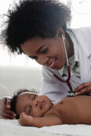 Black woman doctor with baby